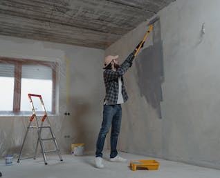 Professional painter working on walls